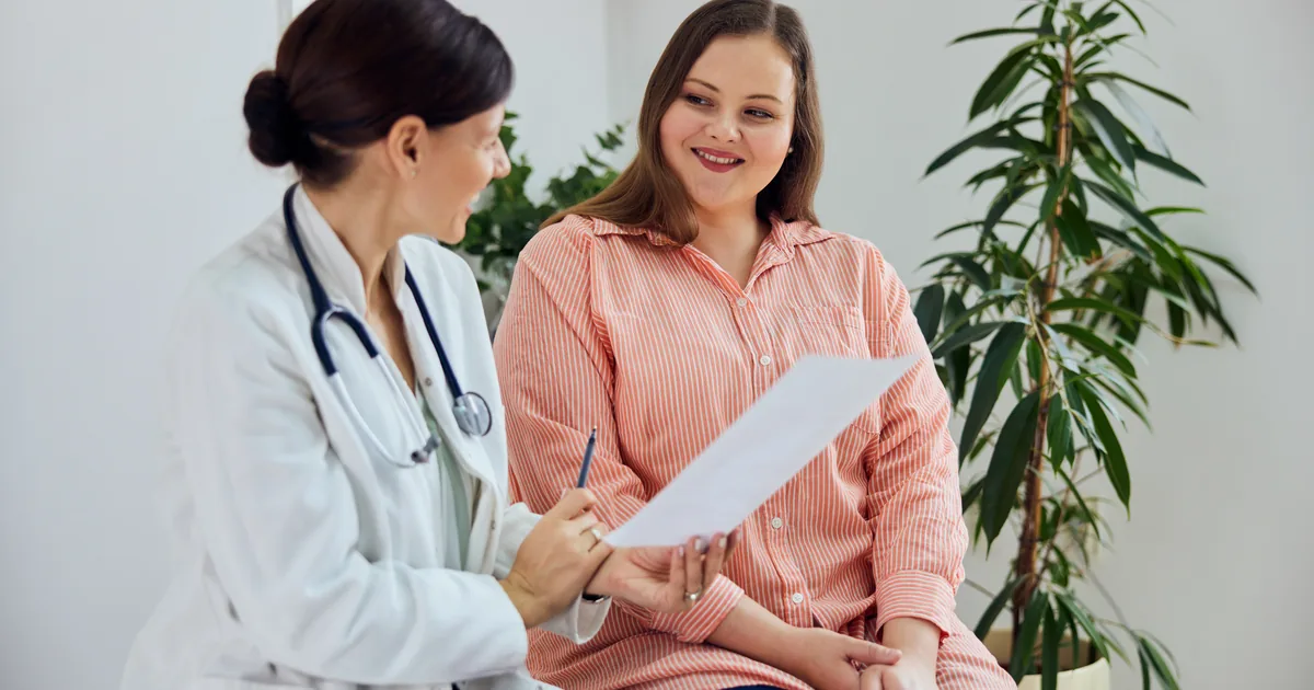 Provider measuring a patient's waist during a medical weight loss consultation at iCRYO St. Johns