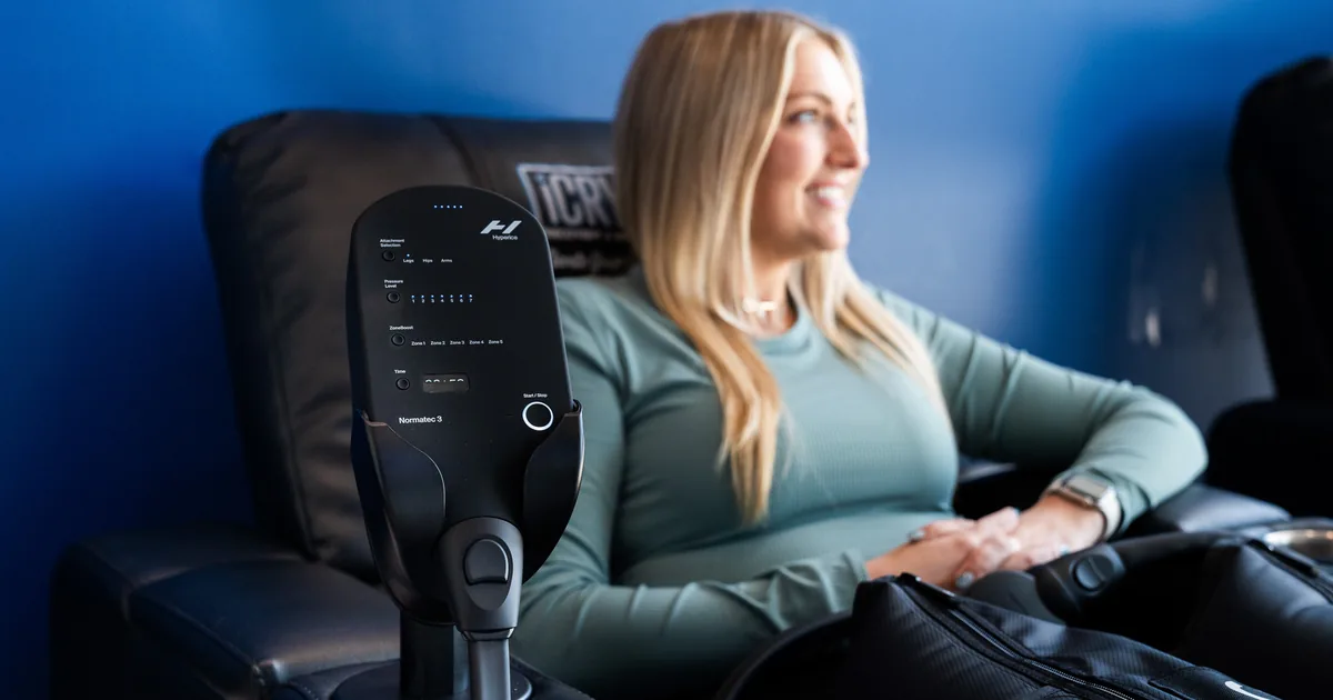 Runner relaxing during compression therapy for recovery at iCRYO St. Johns