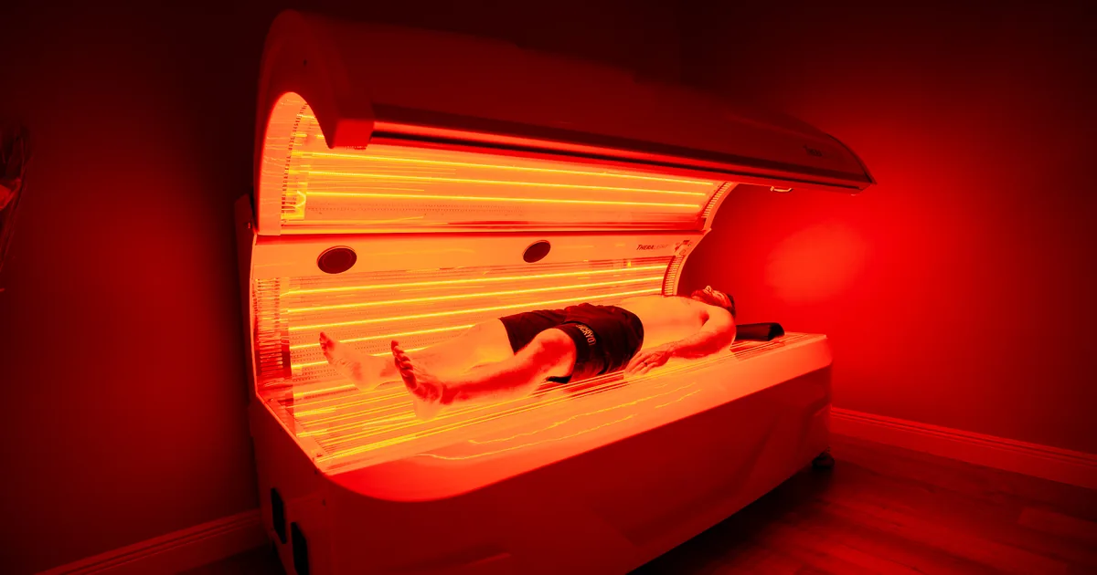 Professional red light therapy bed compared with an at-home red light panel